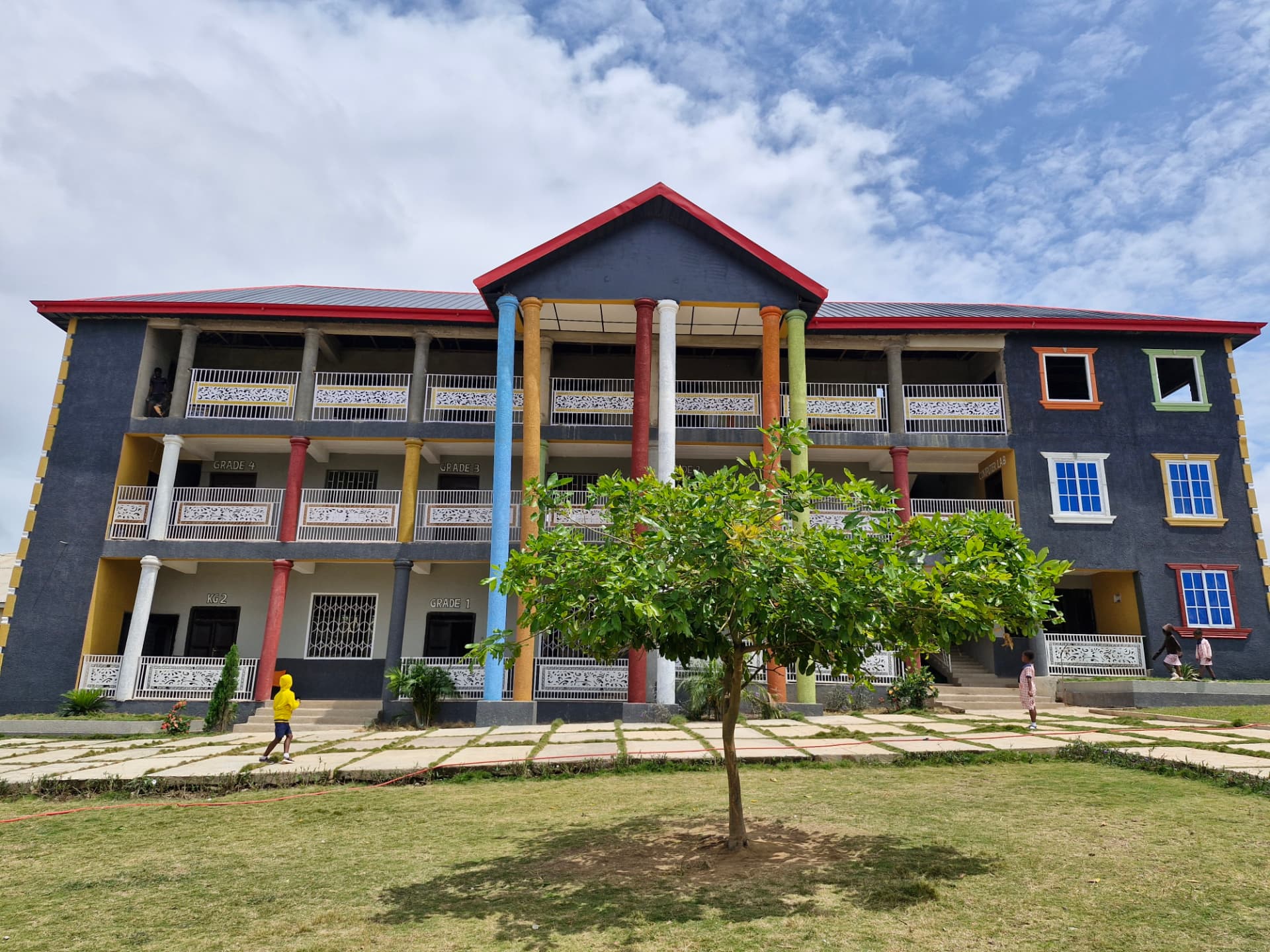 Main Campus three-storey block with colourful pillars at Ahenema Kokoben