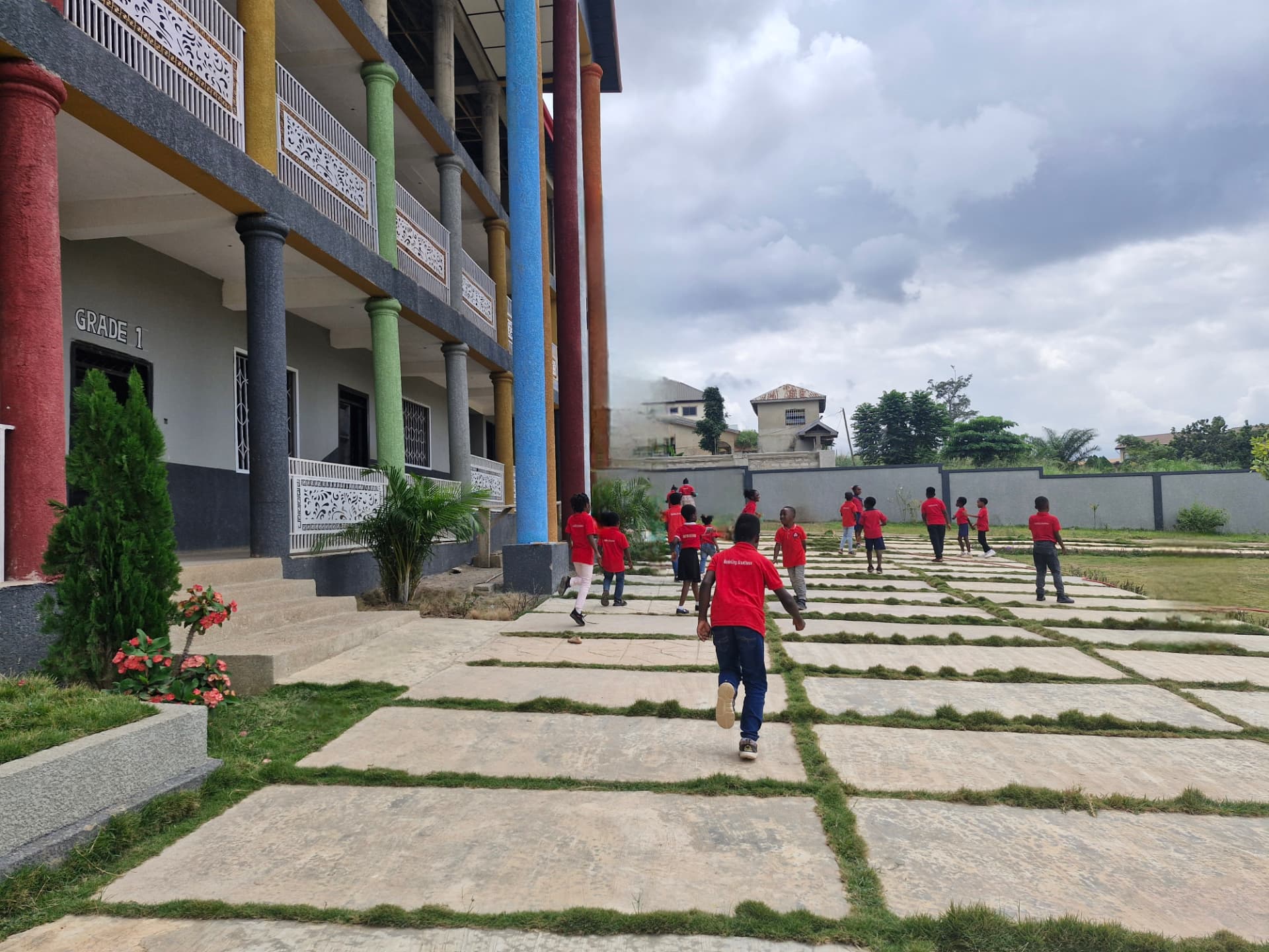 Pupils in red uniforms on the Samrose's Academy campus grounds